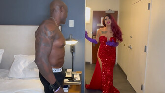 Beautiful lady in a red dress in a hotel room