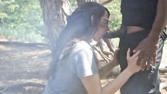 MILF blows black cock in the woods