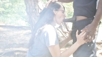 MILF blows black cock in the woods