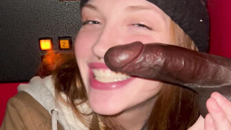 Gloryhole Redhead smiles at thick black cock