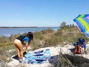 Japanese wife doing yoga on the beach